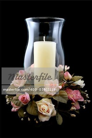 Holiday Candle and Flower Centerpiece on Isolated Black Background