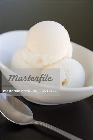 Three Scoops of Lemon Sorbet with a spoon on a table