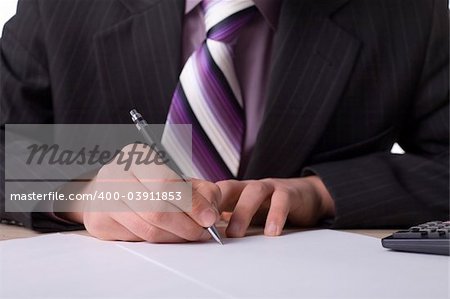 Businessman at the desk with signing agreement.