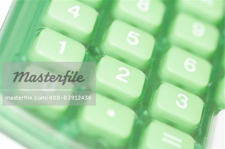 Close-up of buttons on a green colored calculator.