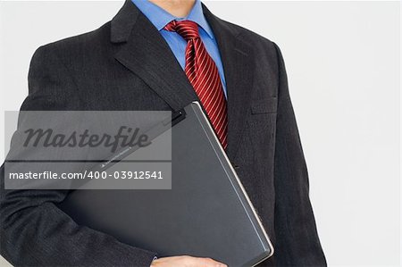Business man with a laptop on is arm