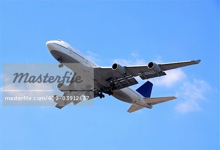 Passenger airplane flying in bright blue sky