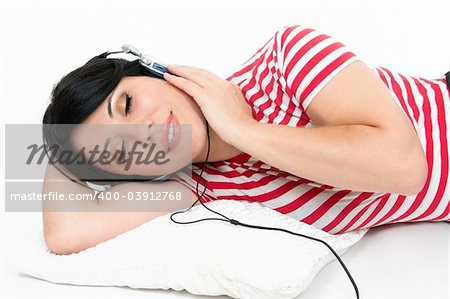 A woman at leisure relaxes to some music