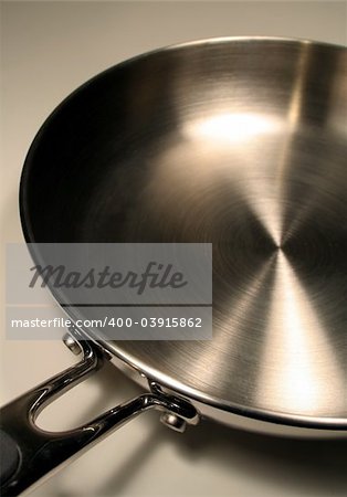 A close up of a stainless steel frying pan.