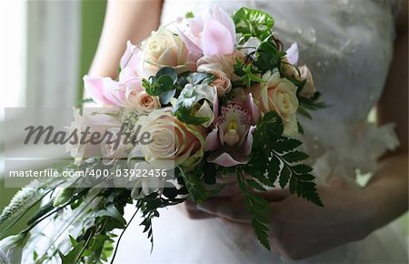 Wedding hands on a bridal bouquet