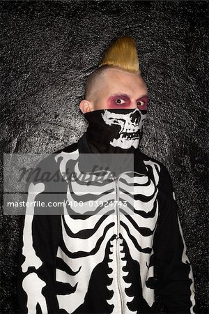 Mid-adult Caucasian male punk wearing skeleton sweatshirt and skeleton bandanna.