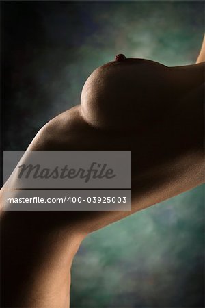 Side view of nude Caucasian female body arching backwards.