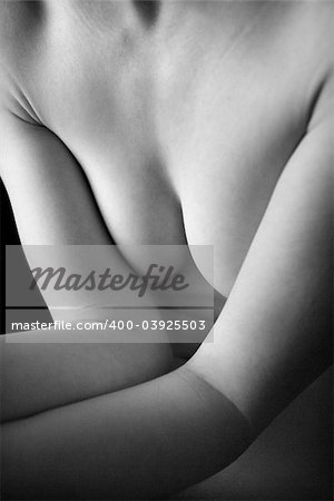 Chest and arms of nude young adult Caucasian woman.