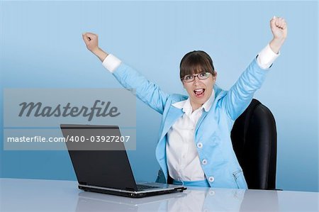 Happy businesswoman working with a laptop on a blue background