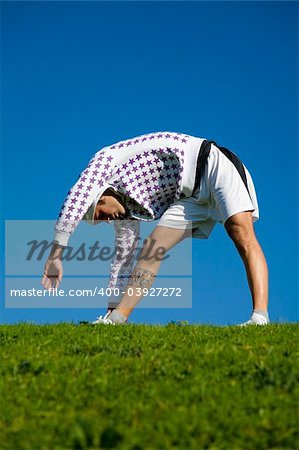 healthy lifestyle: man doing stretching in a park