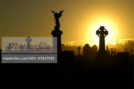 silent evening scene at an old cemetery, silhouettes of graves, crosses and statues, black and yellow dominant colors