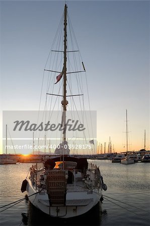 Image shows a sailing boat in marina