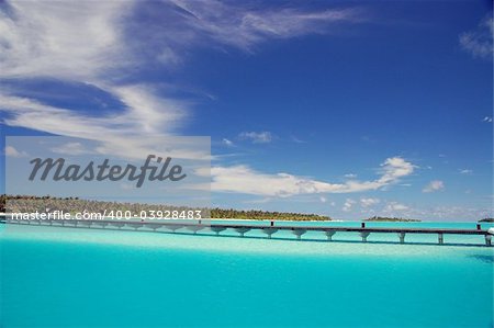 footbridge over turquoise ocean on an maldivian island