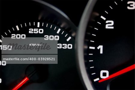 Sportscar dashboard closeup with backlit speedometer