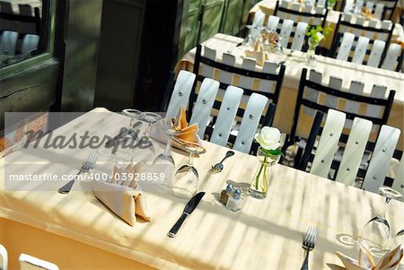 Sunlit restaurant patio with several set tables