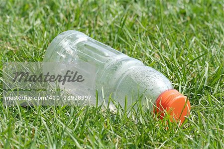 Empty bottle at a field