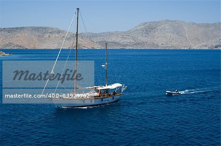 Sailing ship and a small motor boat on the sea