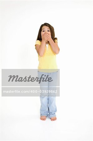 Five year old female child standing on white background with a surprised look  wearing casual clothes