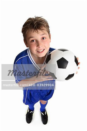 A boy ready for a game of soccer.