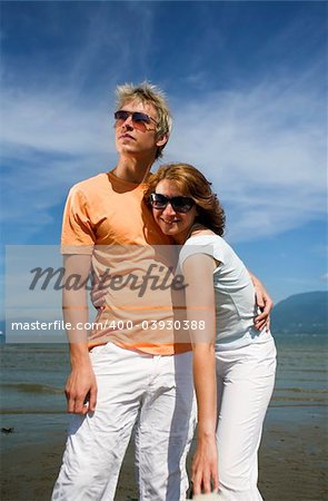 young couple posing on the beach in vancouver