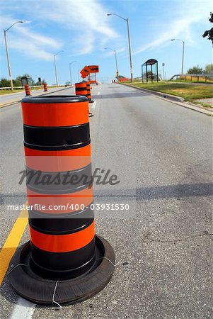 Road construction signs and cones on city street