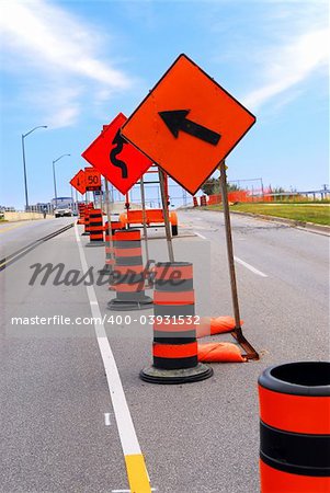 Road construction signs and cones on a city street