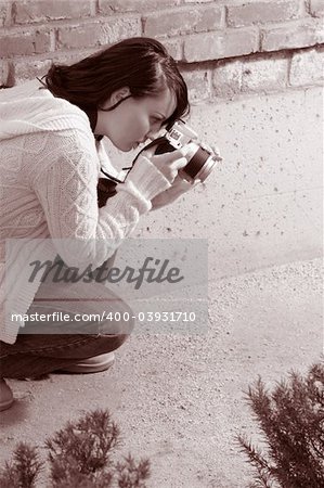 Girl shooting SLR photo camera