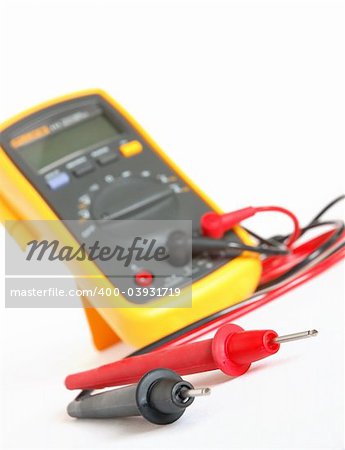 Digital multimeter with black and red probes over white background