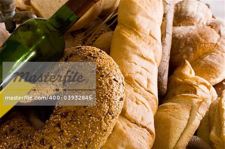 baked bread and a bottle of wine