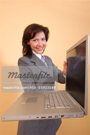 Smiling girl with laptop in her hands