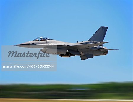 Military jet flying at hogh speed with motion blur