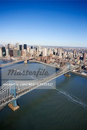 Aerial view of New York City Manhattan Bridge with Brooklyn bridge in background and Manhattan buildings.
