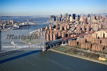 Aerial view of  in New York City Williamsburg Bridge with Manhattan and Brooklyn bridges in background and view of lower east Manhattan.