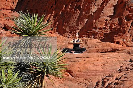 Doing yoga on red rocks