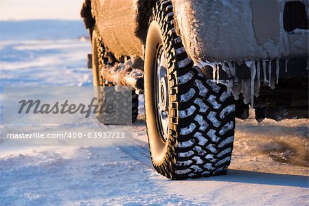 Close up of truck on ice covered road.