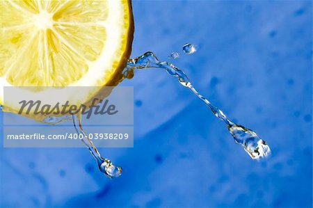 Yellow refreshing lemon against the blue background