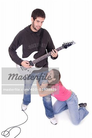 Young electric guitar player with beautiful young girl grabbing his leg