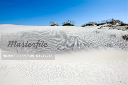 Blues sky with clouds over sandy dunes