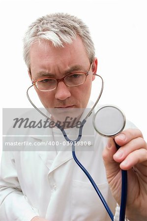 pensive doctor in glasses listening the stethoscope. Soft-focused, focal point is on face
