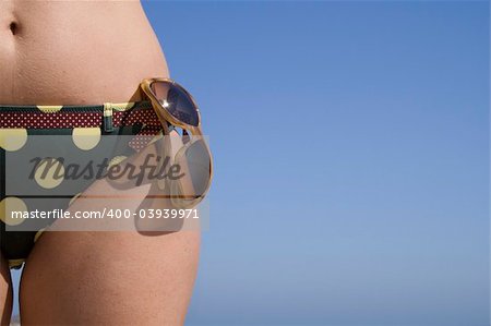 a woman with her sunglass in her bikini