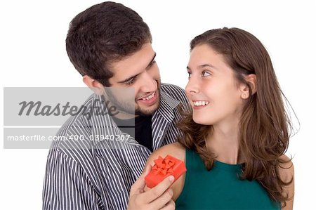 Young couple. Man giving a present to a beautiful young woman.
