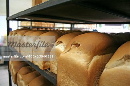 Loaves of bread arranged in rows in a bakery