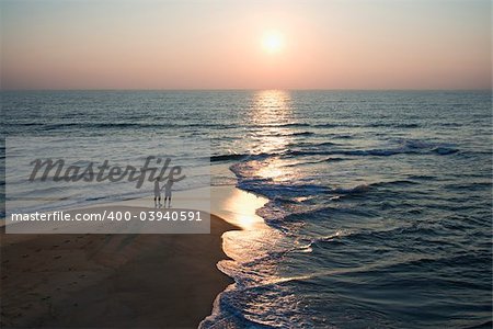 Aerial view of couple on beach in Bald Head Island, North Carolina during sunset.