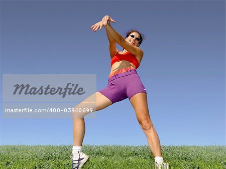 Girl exercising outdoors on the grass