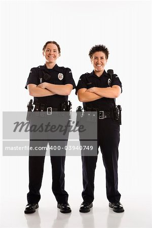 Portrait of two mid adult Caucasian policewomen standing with arms crossed looking at viewer smiling.