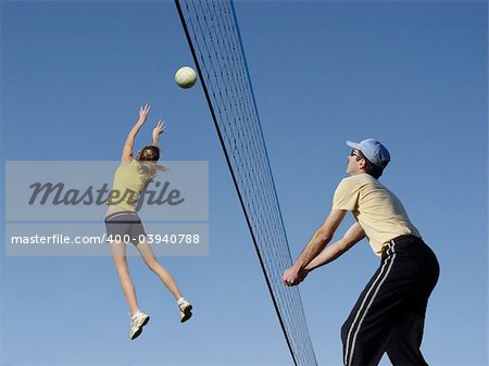 Men and a girl playing volleyball