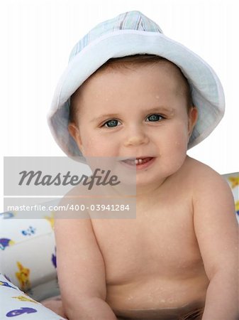 Cute baby in a hat taking a bath