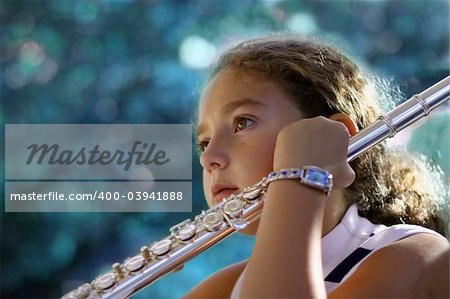 Girl with a flute listening to her teacher