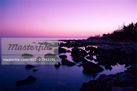 Fantastic scene of pink sky reflection at rocky bay