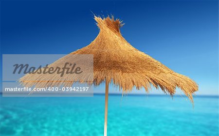 Relaxing on Tropical Beach under umbrella on sunny day